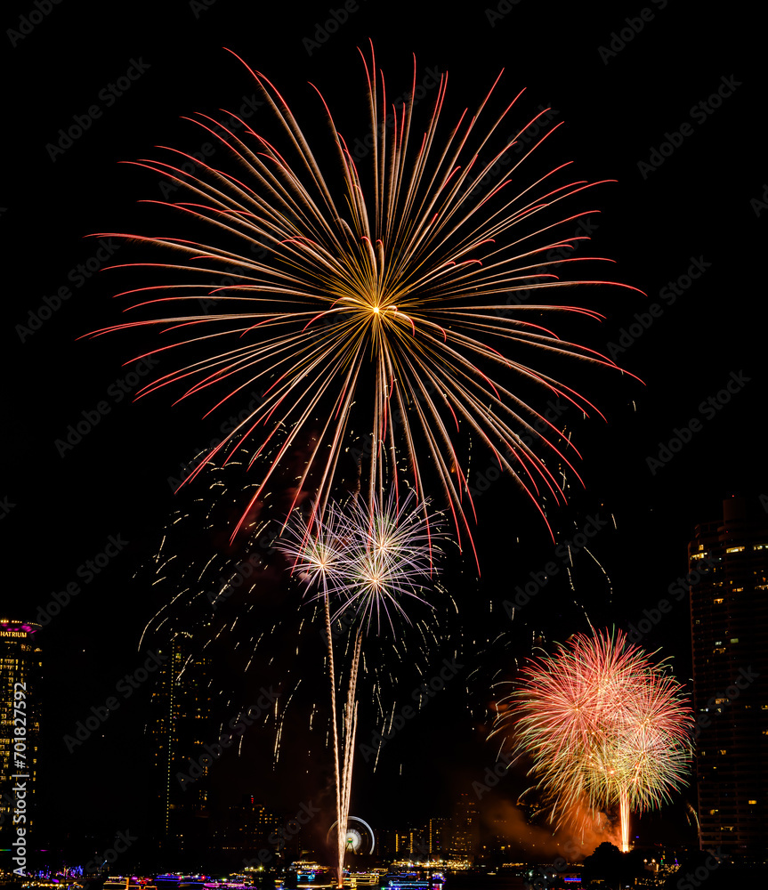 Firework show to celebrate of the new year 2024 along Chao Praya River with the night scene on Asiatique landmark side in Bangkok city, Thailand.