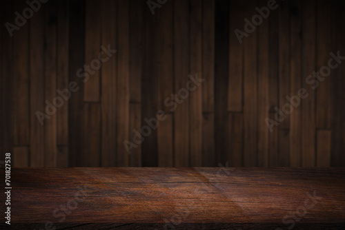 Empty space on a wooden table for product display with a blurred brown wooden wall background..