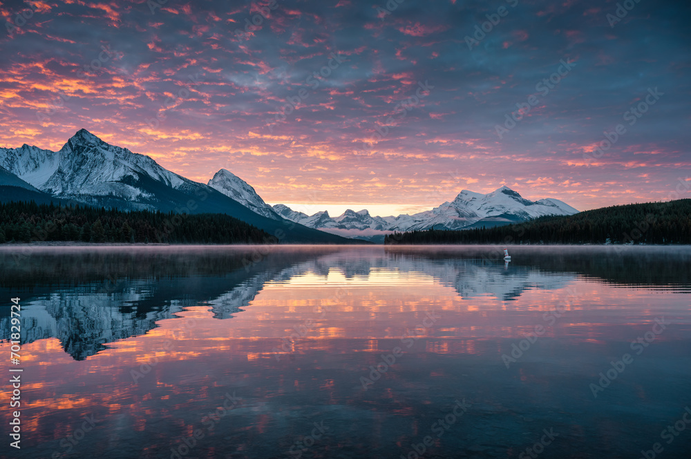 Rocky mountains with colorful sky reflection in Maligne Lake at Jasper national park, Canada