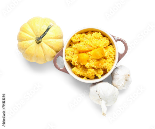 Pot of tasty millet porridge with pumpkin and fresh vegetables on white background