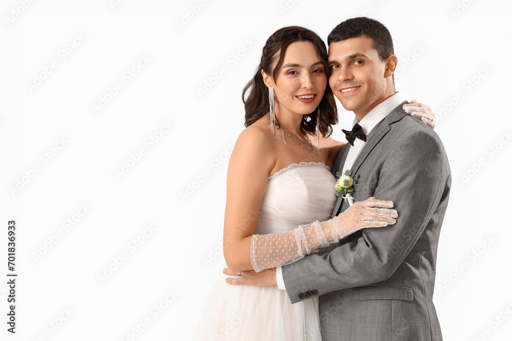 Young wedding couple hugging on white background Young wedding couple hugging on white background