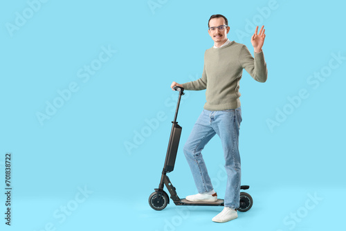 Young man with kick scooter...