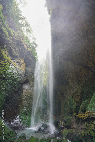 Waterfalls in the canyon fall from the sky. Like a silver-white chain. The Three Natural Bridges are a series of natural limestone bridges  Chongqing.