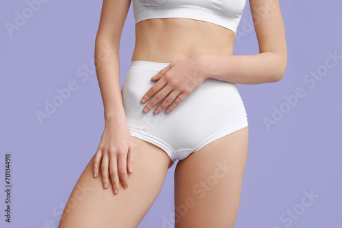 Beautiful young woman after depilation of legs on purple background, closeup © Pixel-Shot