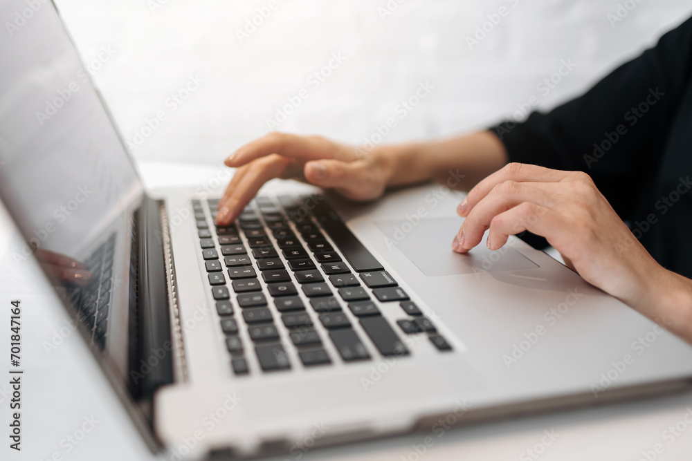 Close up woman's hands typing on laptop keyboard at home office. Businesswoman or student girl using pc for online internet marketing, freelance, work from home, education online, distance studying Close up woman's hands typing on laptop keyboard at home office. Businesswoman or student girl using pc for online internet marketing, freelance, work from home, education online, distance studying