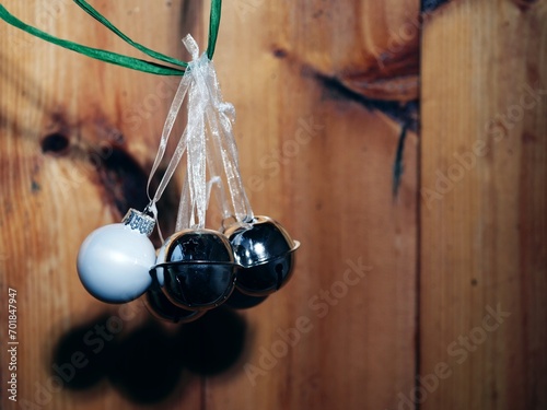 Silver Christmas baubles and bells on rustic wooden background