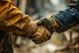 Building the Future: Close-up of Two Builders Shaking Hands on a Construction Site