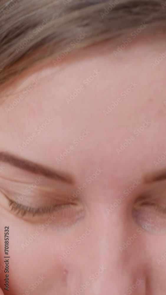 A young woman holds her hand near her head and feels a severe headache. Close up. Vertical video A young woman holds her hand near her head and feels a severe headache. Close up. Vertical video