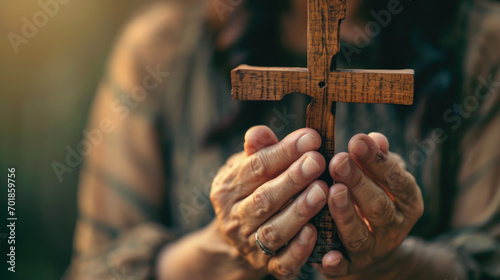 Pair of hands clasped around a wooden cross, conveying a sense of faith, prayer, and spirituality