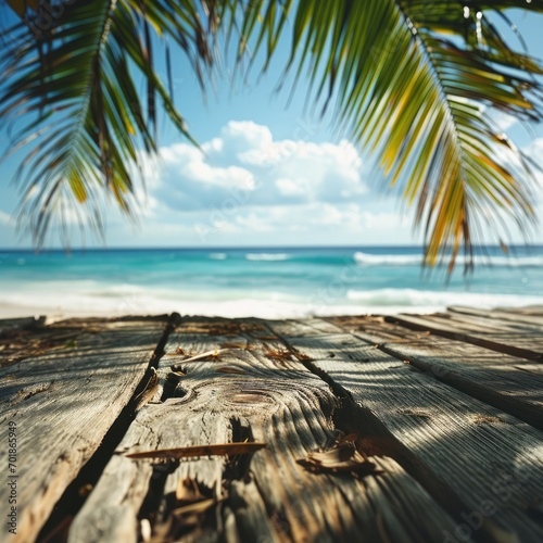 An inviting scene of a wooden deck leading the gaze to a sparkling sea under a bright, sunlit sky, fringed by gentle palm leaves