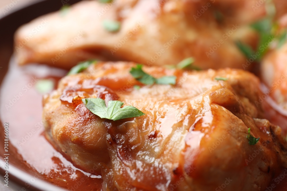 Tasty cooked rabbit meat with sauce and parsley, closeup Tasty cooked rabbit meat with sauce and parsley, closeup