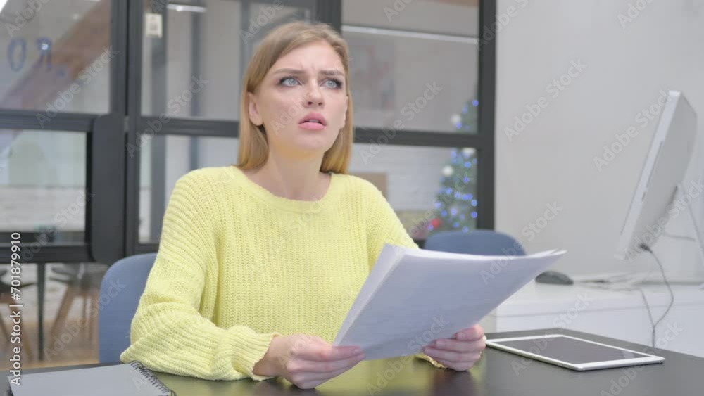 Young Blonde Woman Feeling Upset while Reading Contract Young Blonde Woman Feeling Upset while Reading Contract