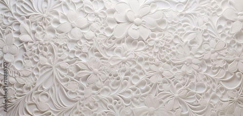 Delicate lace-like pattern in soft white on a 3D wall texture