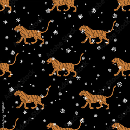 Seamless seasonal winter pattern with walking tigers and snowflakes. Traditional animal design from India. On black background.