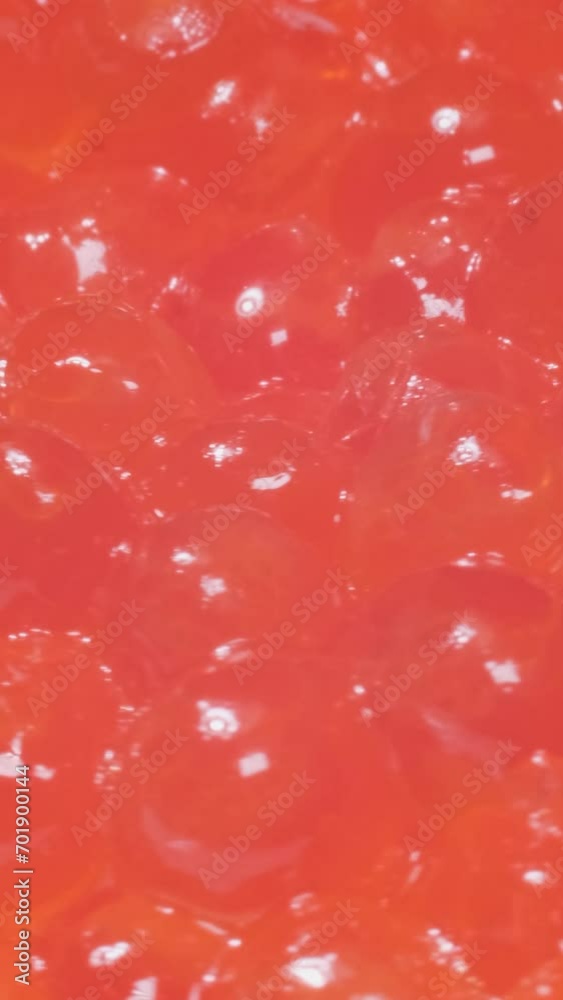 Salmon roe rotates in a circle. Red caviar. Close up. Vertical video Salmon roe rotates in a circle. Red caviar. Close up. Vertical video