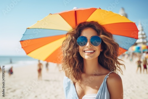 happy woman on the beach in summer against the background of the sea or ocean and colorful umbrella