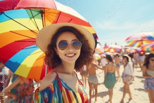 happy asian woman on the beach in summer against the background of the sea or ocean and colorful umbrella