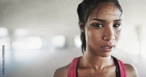 Sweat, fitness and face of woman in gym for intense training, exercise and cardio workout. Sports, athlete and portrait of person breathe, rest and fatigue for wellness, healthy body and lose weight photo