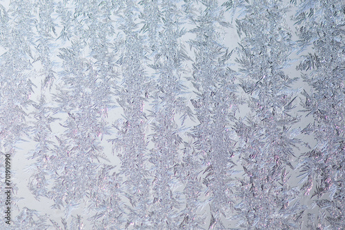 Pattern of ice frost on the glass of window. Winter background ant texture. Close up
