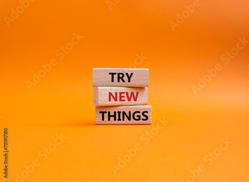 Try new Things symbol. Concept words Try new Things on wooden blocks. Beautiful orange background. Business and Try new Things concept. Copy space.