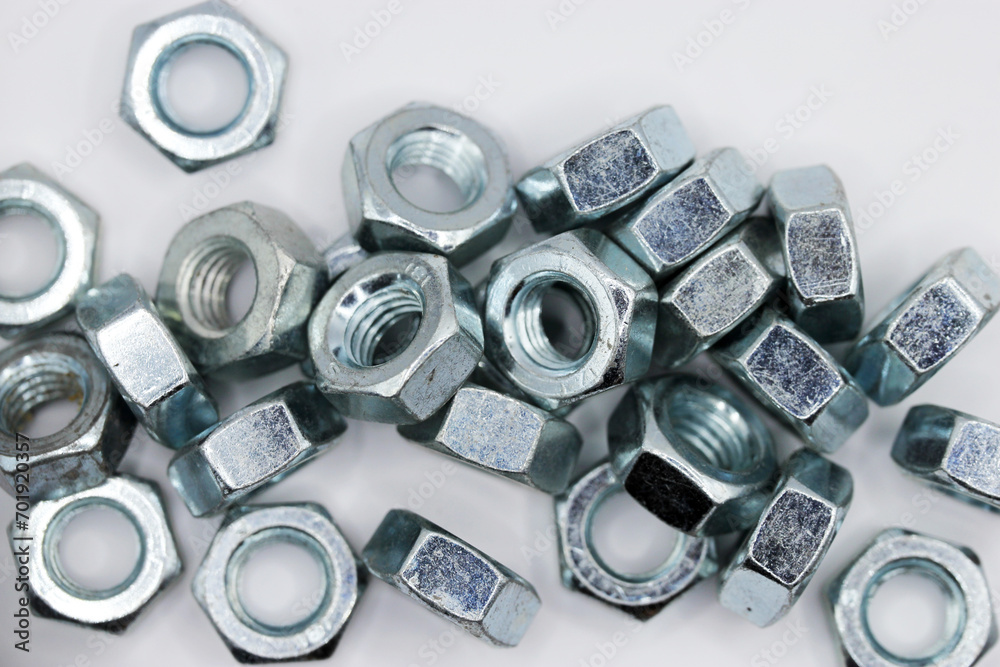 Fasteners. Metal nuts on a white background Fasteners. Metal nuts on a white background