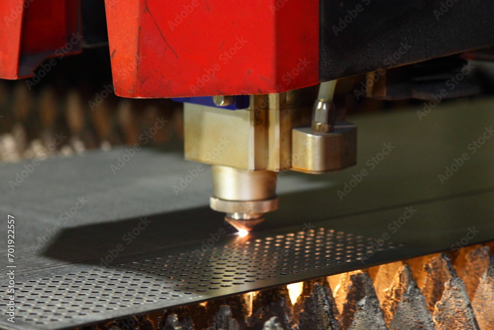 Laser cutting of metal sheet and punching holes on a CNC machine with flame on torch - obrazy, fototapety, plakaty 