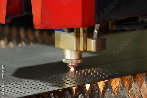 Laser cutting of metal sheet and punching holes on a CNC machine with flame on torch photo