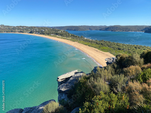 Narrow peninsular is surrounded by water on two sides. Panorama of the ocean. View of the mountain and the island's coastline. Palm beach, Australia, NSW. Beach that divides the ocean. photo