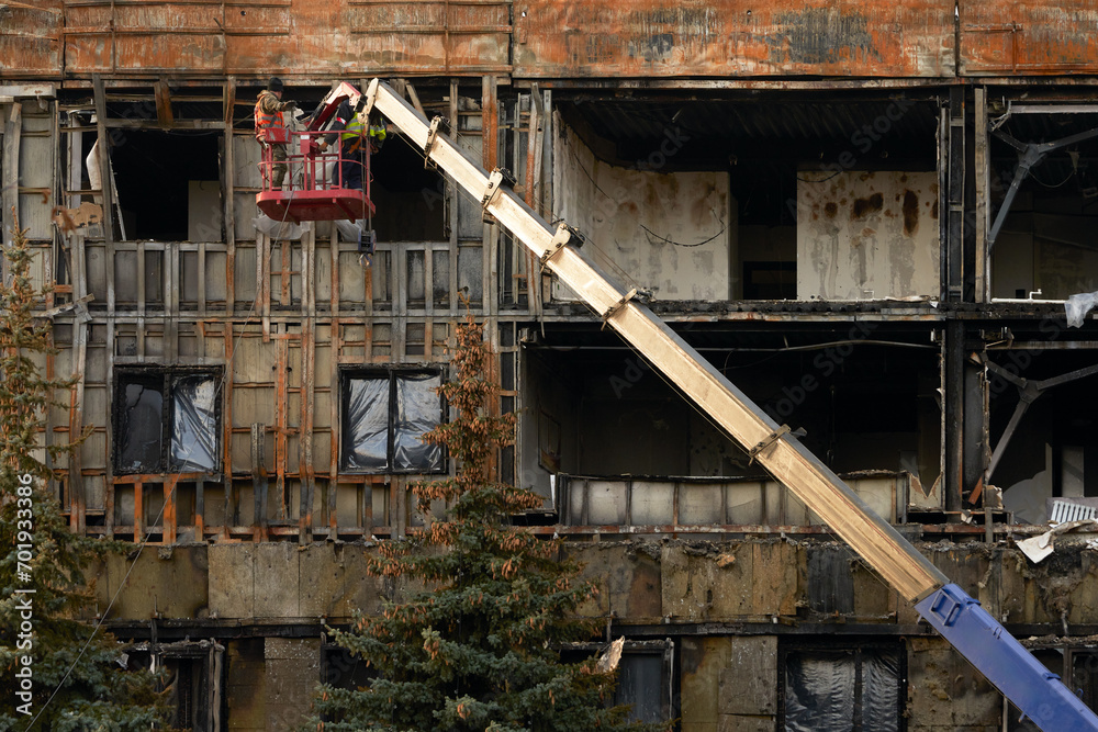 Building experts assess fire damage to a building. Building experts assess fire damage to a building.
