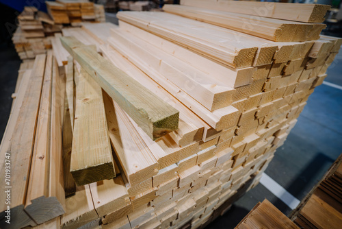 stack of freshly cut and planed wooden planks and beams photo