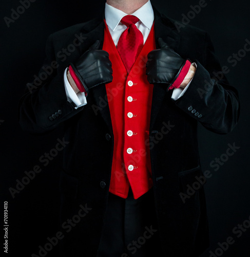 Portrait of Stylish Man in Dark Suit and Leather Gloves Wearing Red Tie and Red Vest or Waistcoat. Vintage Style and Retro Fashion.