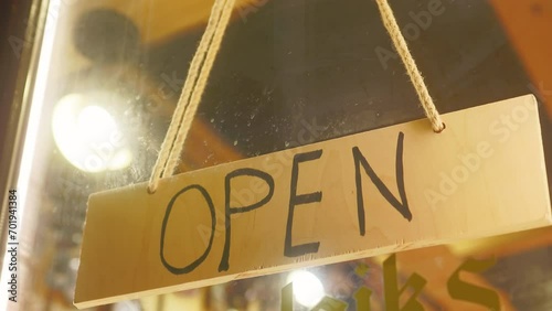 Wooden open sign showcased on shop counter photo