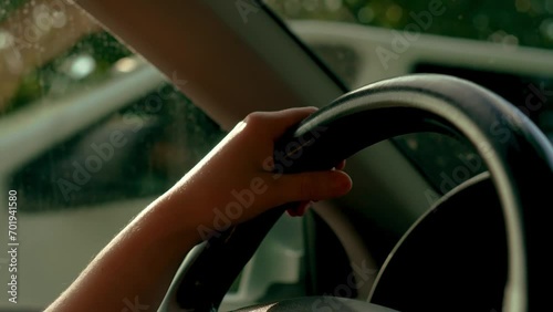 Woman driving car with hands on steering wheel to control vehicle close up. Adult female having safety ride in vehicle. Young traveling travelling by SUV
