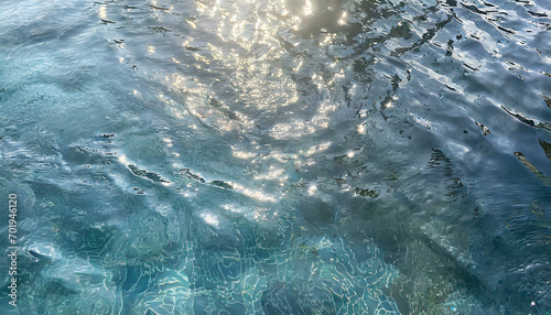 background of the blue sea water surface with sun rays and lens flare