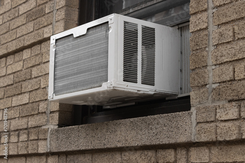 Tablou pe pânză exterior view of air conditioning window unit extruding from the window sill of
