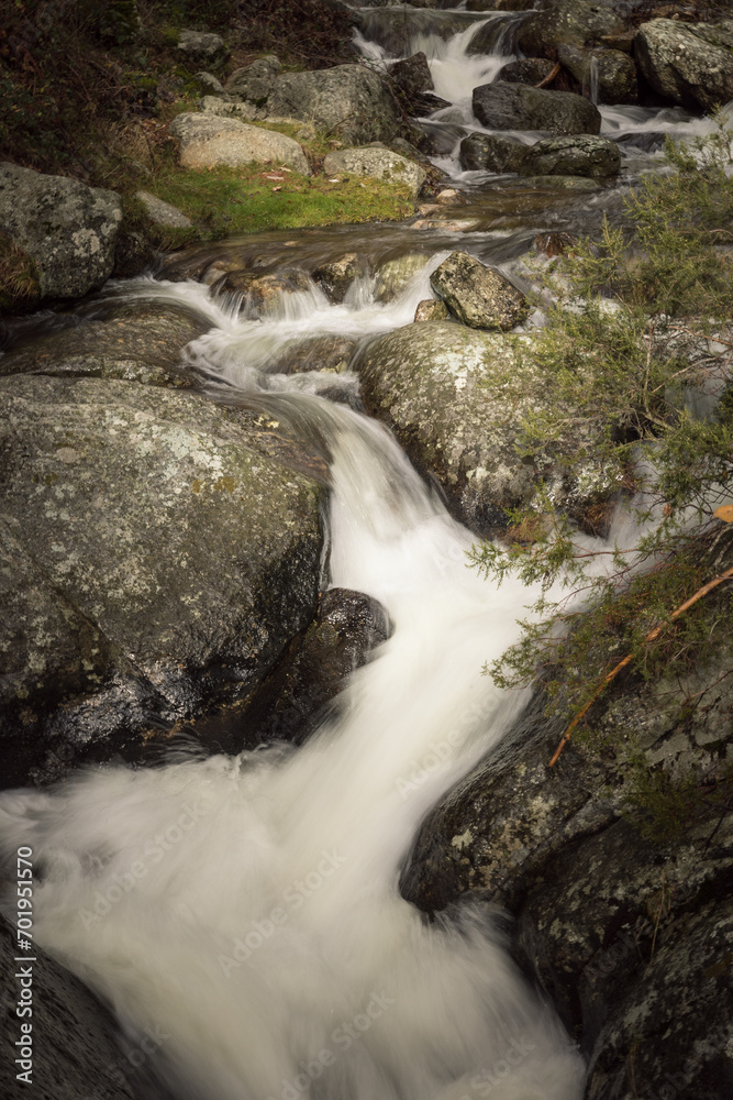 river with swirling water and rocks in the forest, beautiful scenery with rushing water in the river