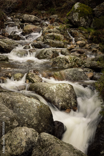river with swirling water and rocks in the forest, beautiful scenery with rushing water in the river