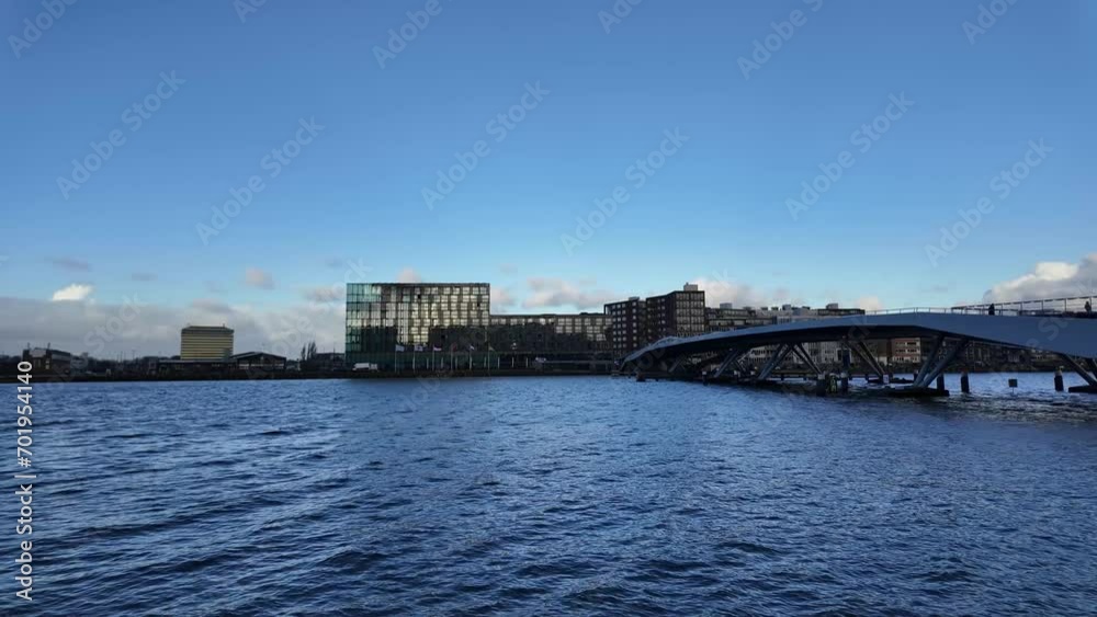 Panoramic shot of the Jan Schaeferbrug bridge to Java-eiland over IJhaven river shot from Veemkade in Amsterdam, sunset, pan right Panoramic shot of the Jan Schaeferbrug bridge to Java-eiland over IJhaven river shot from Veemkade in Amsterdam, sunset, pan right