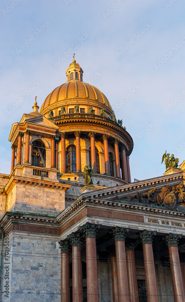 Fototapeta premium The golden dome of St. Isaac's Cathedral in St. Petersburg against the blue sky.