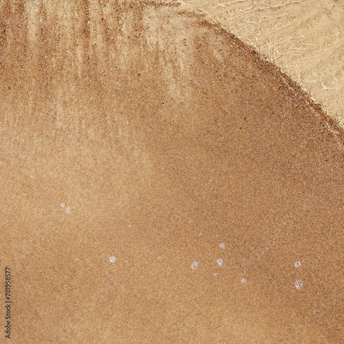 Fototapeta Naklejka Na Ścianę i Meble -  Sea water touch wet sand. Summer holiday to Baltic sea. Empty sandy beach top view.