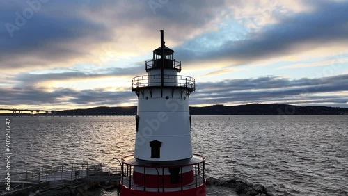 A lighthouse standing brilliant at sunset