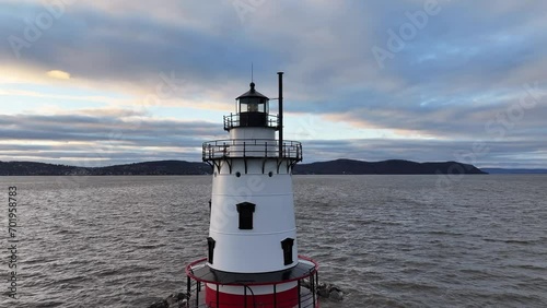 A lighthouse standing brilliant at sunset