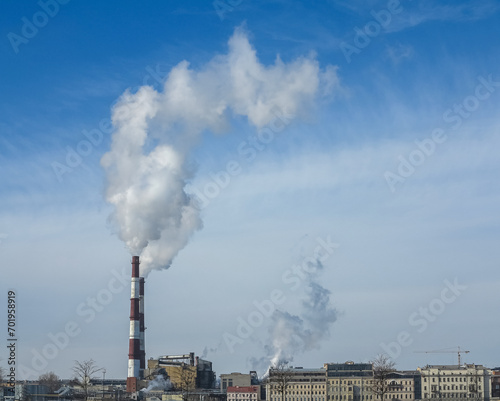 The chimney emits exhaust gases into the blue sky. The concept of air pollution and the environment.  © Dmitry Presnyakov