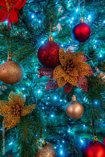 Close up view of decorations and lights on a Christmas tree
