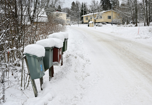 snow covered mailboxes and a road in a small Finnish town © Mikhail Olykainen