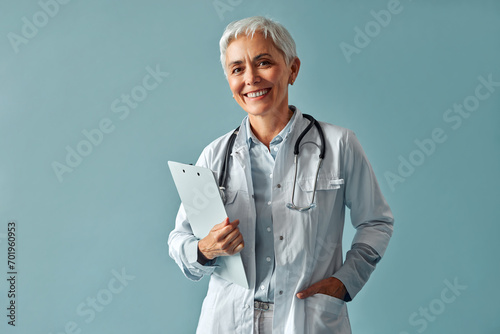 Family doctor. A female employee of a medical clinic poses on a blue background.