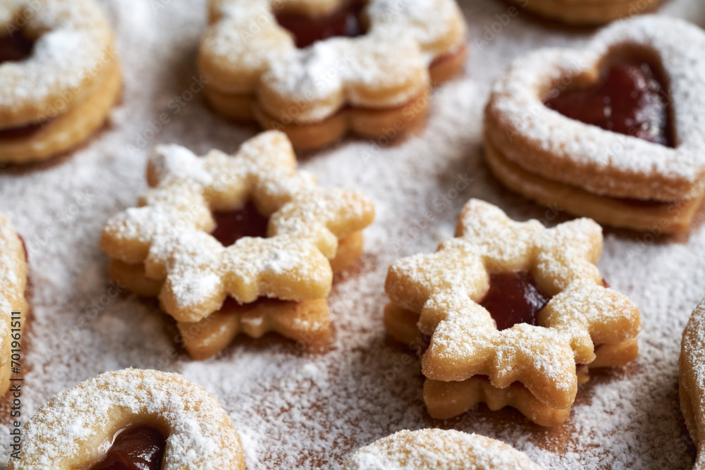 Linzer Christmas cookies filled with red strawberry marmalade and dusted with sugar