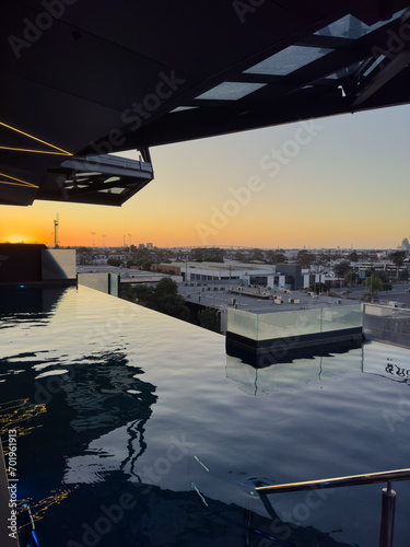 Sunset Serenity: Infinity Pool Views Overlooking Melbourne's Cityscape from a Luxurious Hotel