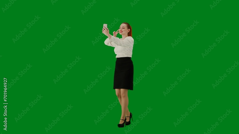 Portrait of attractive office girl on chroma key green screen. Woman in skirt walking holding gift bags taking selfie on smartphone. Half turn. Portrait of attractive office girl on chroma key green screen. Woman in skirt walking holding gift bags taking selfie on smartphone. Half turn.