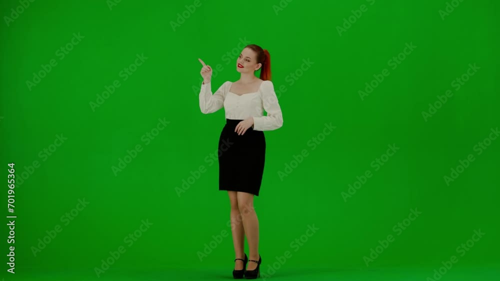 Portrait of attractive office girl on chroma key green screen. Woman in skirt and blouse standing pointing at empty areas smiling at camera. Portrait of attractive office girl on chroma key green screen. Woman in skirt and blouse standing pointing at empty areas smiling at camera.